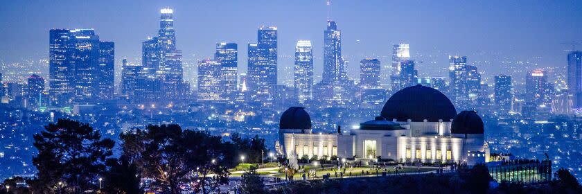 Dusk settles in over the city in a view from above the Griffith Park Observatory toward downtown Los Angeles