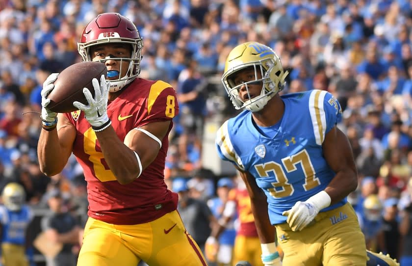 Wally Skalij  Los Angeles Times STOPPING TALENTED RECEIVER Amon-ra St. Brown, shown catching a pass in front of UCLA's Quentin Lake last season, has been a problem for USC's young secondary during training camp.
