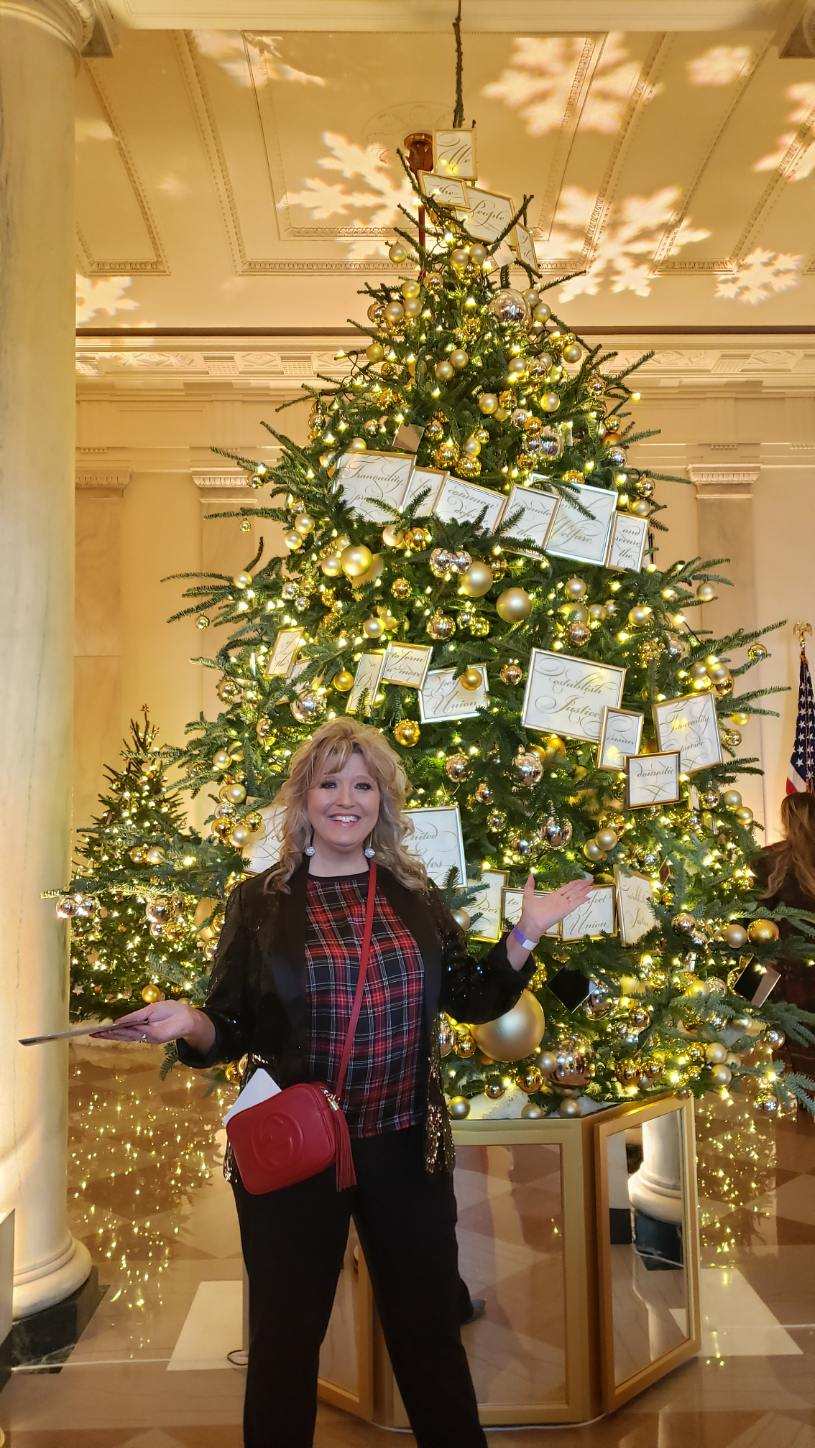 Jill Pangas of Copley show one of the trees that she helped decorate in the grand foyer of the White House.