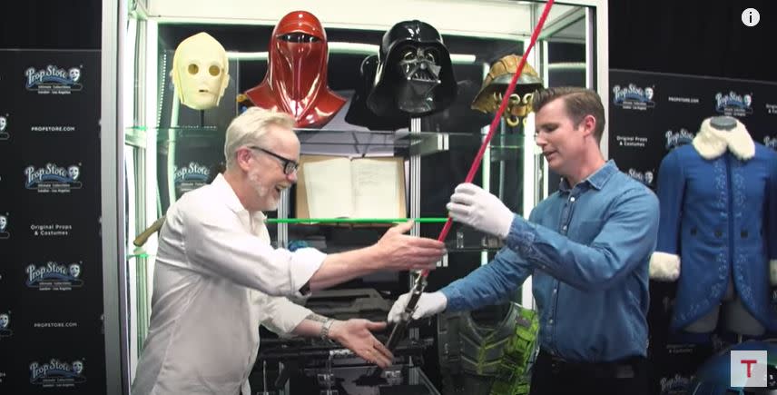 Adam Savage handles a prequel era lightsaber prop.