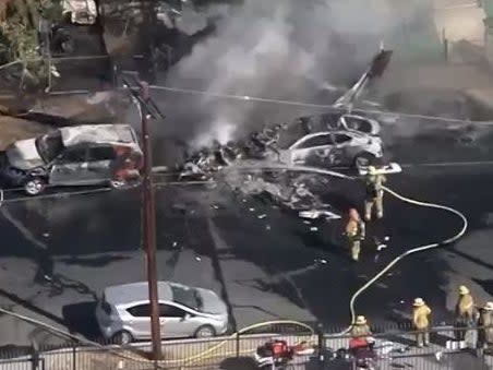 A small plane crashed into a neighborhood in the San Fernando Valley, leaving cars and a yard engulfed in flames. (NBC 4 Los Angeles)