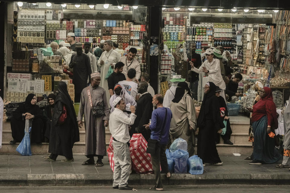 Muslim pilgrims buy souvenirs at a shop near the Grand Mosque, during the annual hajj pilgrimage, in Mecca, Saudi Arabia, Thursday, June 22, 2023. Muslim pilgrims are converging on Saudi Arabia's holy city of Mecca for the largest hajj since the coronavirus pandemic severely curtailed access to one of Islam's five pillars. (AP Photo/Amr Nabil)