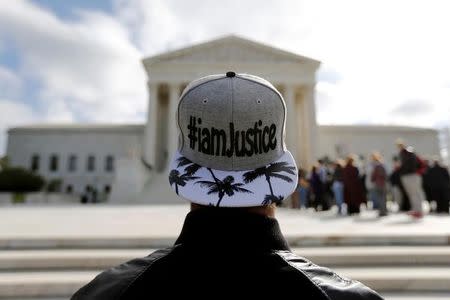 An anti-abortion protester demonstrates outside the U.S. Supreme Court building on the first day of the court's new term in Washington, October 5, 2015. REUTERS/Jonathan Ernst