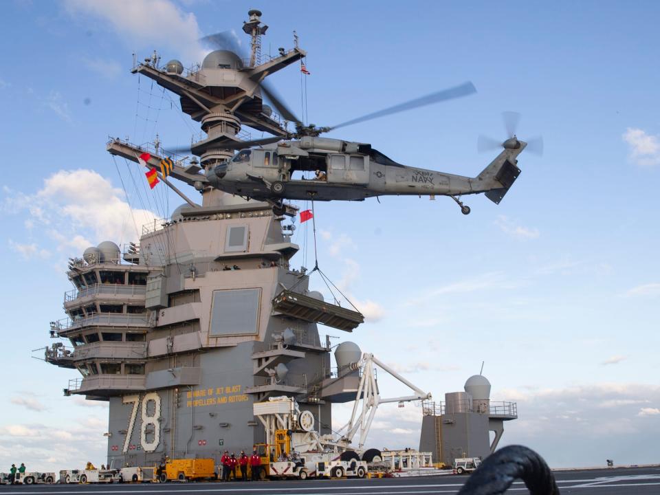 Helicopter lands on flight deck of USS Gerald R. Ford.