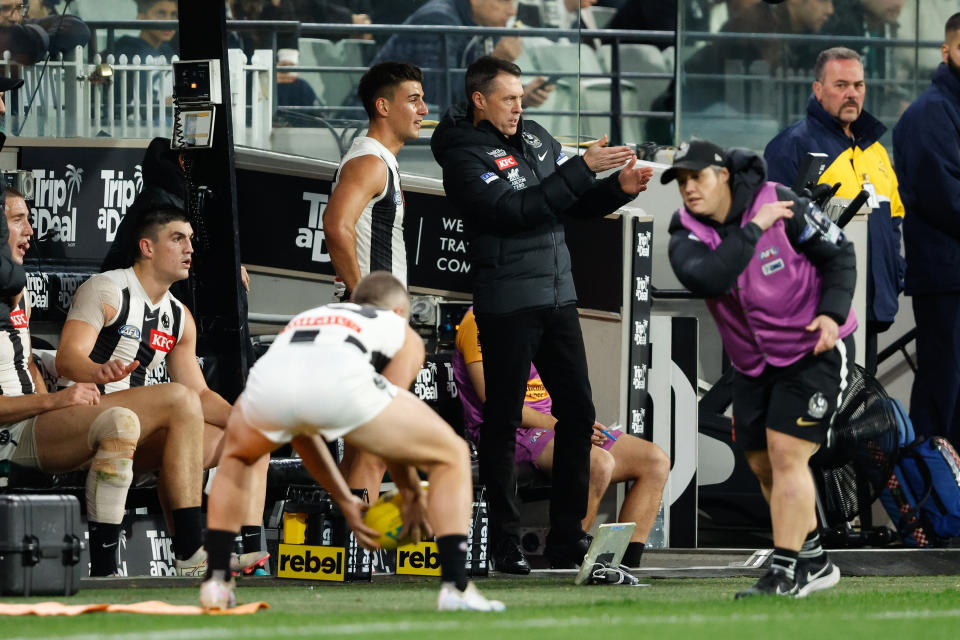 MELBOURNE, AUSTRALIA - MAY 03: Craig McRae, Senior Coach of the Magpies speaks with Nick Daicos of the Magpies on the bench during the 2024 AFL Round 08 match between the Carlton Blues and the Collingwood Magpies at The Melbourne Cricket Ground on May 03, 2024 in Melbourne, Australia. (Photo by Dylan Burns/AFL Photos via Getty Images)