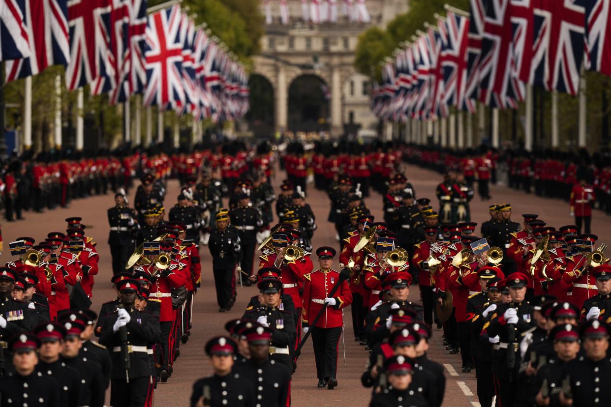 Military personnel parade as the coffin of Queen Elizabeth II is carried following her funeral service in Westminster Abbey.