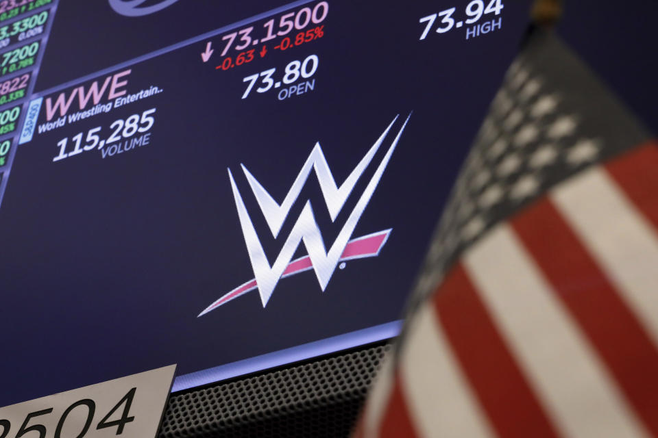 The logo for World Wrestling Entertainment, WWE, appears above a trading post on the floor of the New York Stock Exchange, Sept. 13, 2019. Shares of TKO Group, the new company that houses WWE and UFC, opened at $102 per share in their first day of trading on the New York Stock Exchange on Tuesday, Sept. 12, 2023. Endeavor Group Holdings Inc. has closed its previously announced deal with World Wrestling Entertainment Inc. The pairing of WWE with the company that runs Ultimate Fighting Championship creates a $21.4 billion sports entertainment company. (AP Photo/Richard Drew)