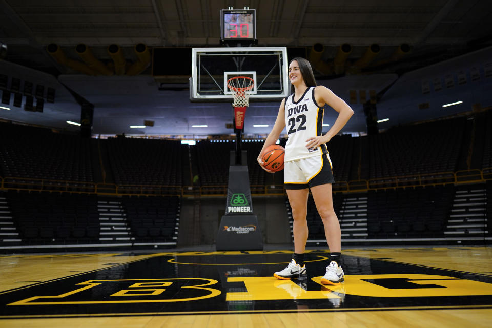 Iowa guard Caitlin Clark poses for photographers during Iowa's NCAA college basketball media day Oct. 4, 2023, in Iowa City, Iowa. Clark is embracing her role as an ambassador for the game after she led Iowa to the NCAA championship game last season. She enters this season with 90 straight double-figure scoring games and a 27.3-point career average. (AP Photo/Charlie Neibergall)