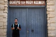 Actor and theater director Aris Laskos poses outside the Theater of Neos Kosmos in Athens, Thursday, Oct. 1, 2020. Laskos based in Athens, hasn't worked since early February and received a one-off support check for 800 euros ($940) shortly after the country's economy was placed in lockdown in the spring due to the pandemic. (AP Photo/Thanassis Stavrakis)