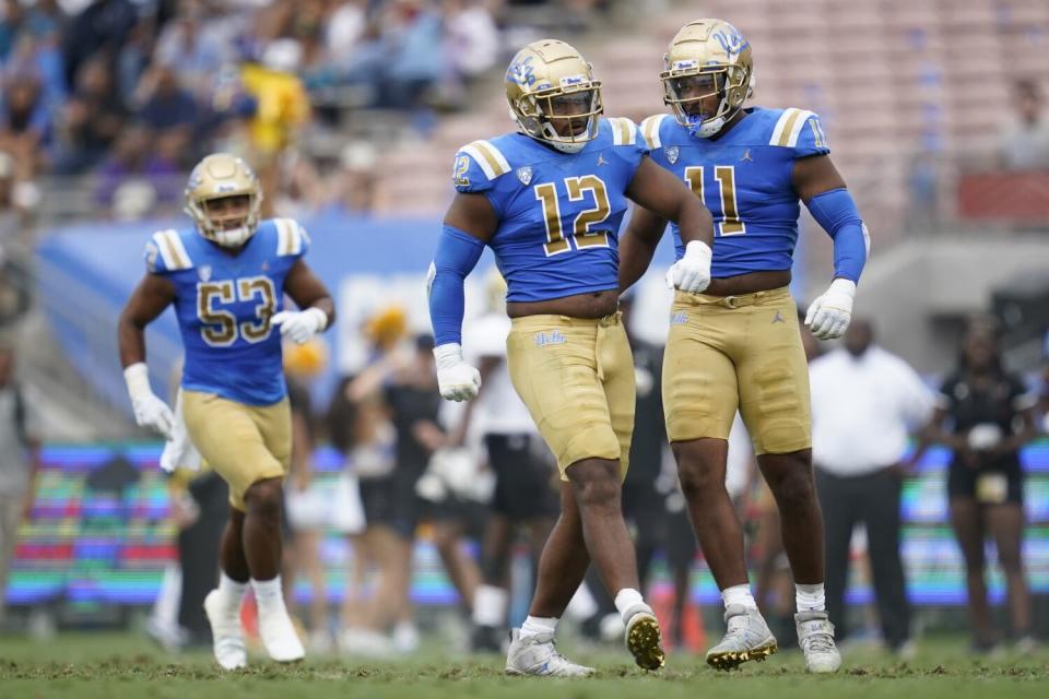 UCLA defensive linemen Grayson (12) and Gabriel (11) Murphy celebrate after a sack against Alabama State.