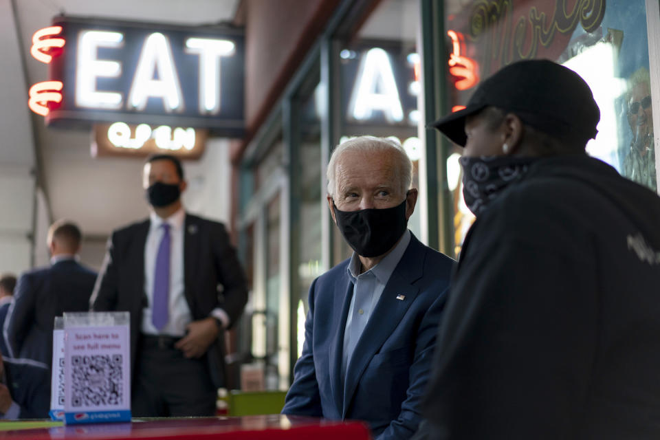 Democratic presidential candidate former Vice President Joe Biden talks with Tia Bozzell, right, of Mert's Heart & Soul restaurant in Charlotte, N.C., Wednesday, Sept. 23, 2020. (AP Photo/Carolyn Kaster)