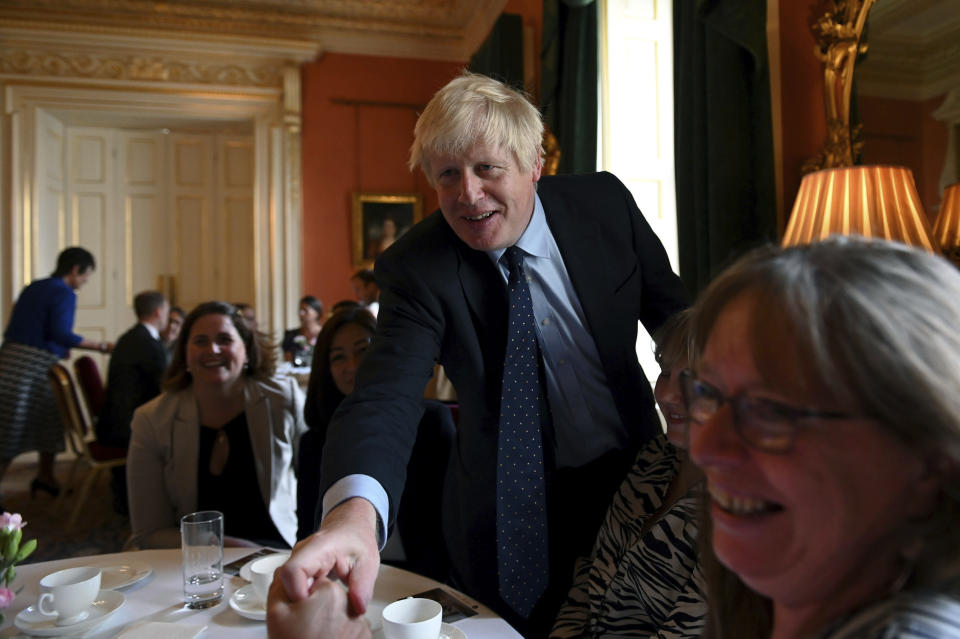 Britain's Prime Minister Boris Johnson speaks with NHS workers during a reception at 10 Downing Street, London, Tuesday, Sept. 3, 2019. Britain's opposition leader has attacked Prime Minister Boris Johnson for trying to run a "cabal" from Downing Street in order to take Britain out of the European Union without a deal despite the costs. (Daniel Leal-Olivas/Pool Photo via AP)