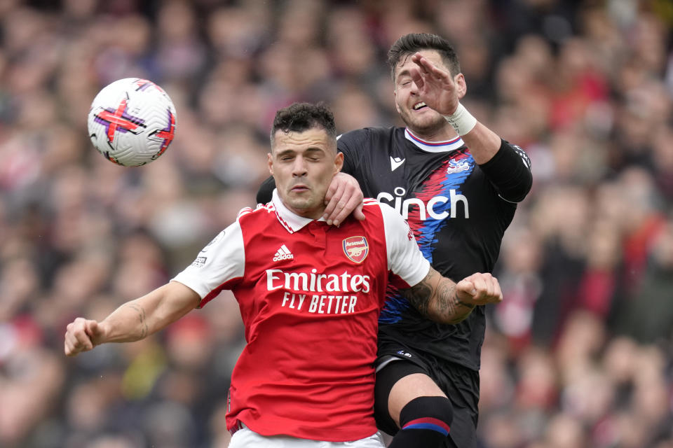 Crystal Palace's Joel Ward, right, challenges for the ball with Arsenal's Granit Xhaka during the English Premier League soccer match between Arsenal and Crystal Palace at Emirates stadium in London, Sunday, March 19, 2023. (AP Photo/Kirsty Wigglesworth)