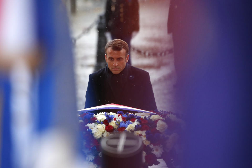 French President Emmanuel Macron lays a wreath of flowers at the tomb of the Unknown Soldier under the Arc de Triomphe in Paris Monday Nov. 11, 2019 during commemorations marking the 101st anniversary of the 1918 armistice, ending World War I. (AP Photo/Francois Mori, Pool)