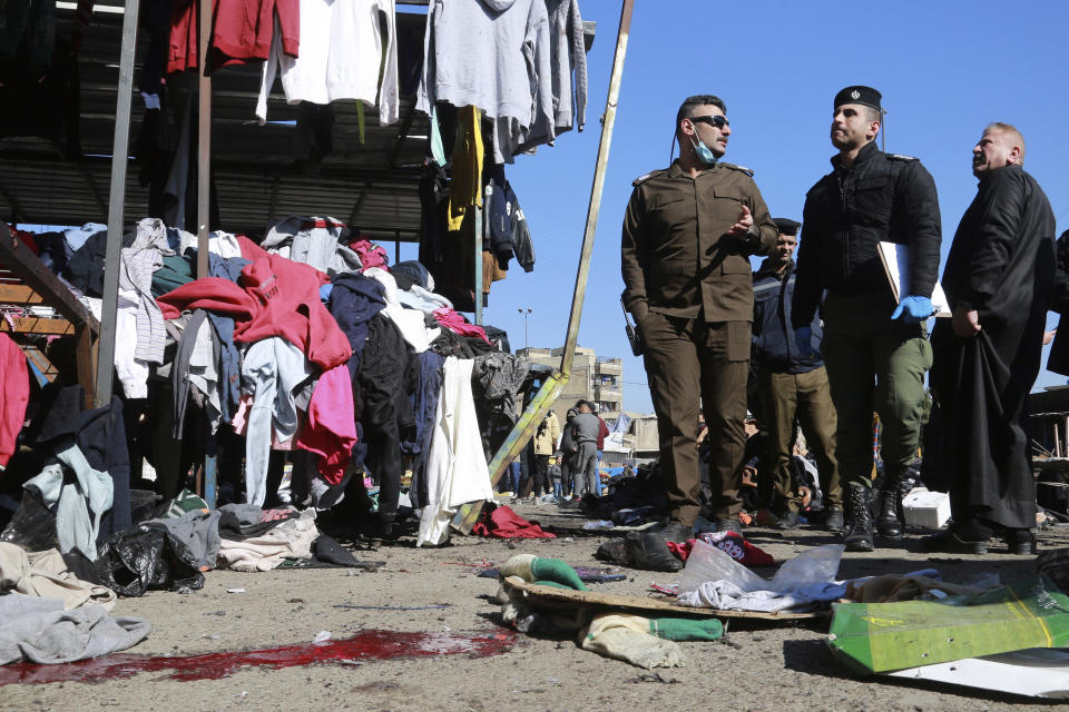 FILE - In this Thursday, Jan. 21, 2021, file photo, security forces work at the site of a deadly bomb attack in a market selling used clothes, in Baghdad, Iraq. The Islamic State group has claimed responsibility for a rare suicide attack that rocked central Baghdad, killing 32 people and wounding dozens. In a statement late Thursday, the group said the bombing “targeted apostate Shiites." (AP Photo/Hadi Mizban, File)