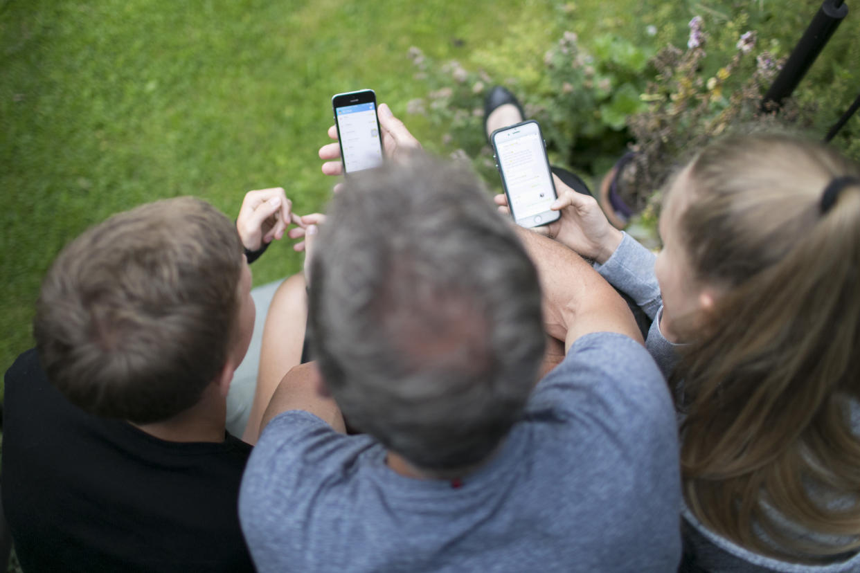 family with smartphones