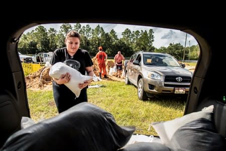 Middleburg residents fill up sand bags with the help of the Clay County Jail inmates