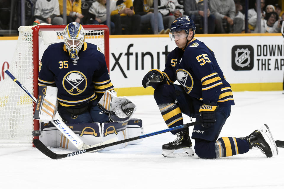 Buffalo Sabres goaltender Linus Ullmark (35), of Sweden, stops a shot against the Nashville Predators as defenseman Rasmus Ristolainen (55), of Finland, helps to defend during the second period of an NHL hockey game Saturday, Jan. 18, 2020, in Nashville, Tenn. (AP Photo/Mark Zaleski)