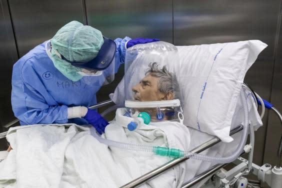 A nurse attends to a Covid-19 patient as he is moved from the ICU (Getty)