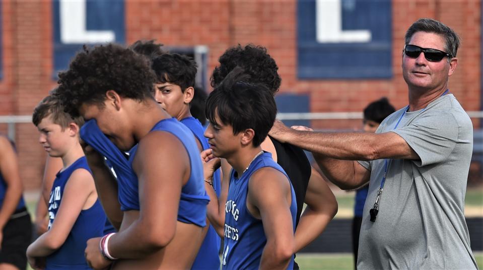 Stamford football coach Wayne Hutchinson, right, directs his players during a strength and conditioning workout July 6 at Stamford High School.