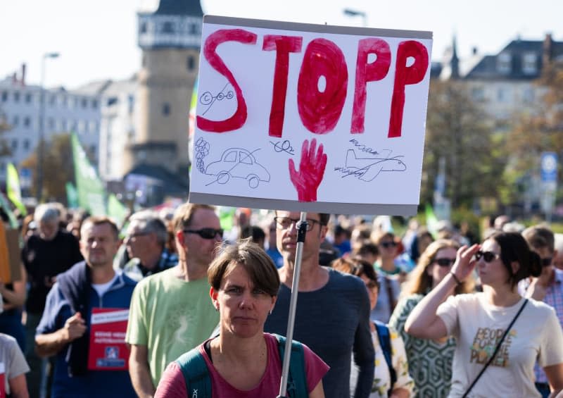 A woman holds a sign during a demonstration to mark the Fridays for Future global climate strike. Boris Roessler/dpa