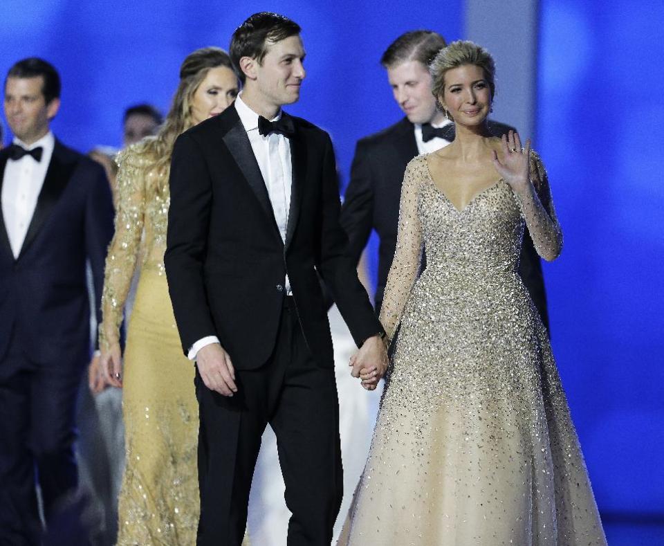 Jared Kushner and Ivanka Trump celebrate with the crowd at the Freedom Ball in Washington, on Friday, Jan. 20, 2017, at the Washington Convention Center during the 58th presidential inauguration. Behind them are Eric Trump and his wife Lara Yunaska and at far left is Donald Trump Jr.. (AP Photo/Mark Tenally)