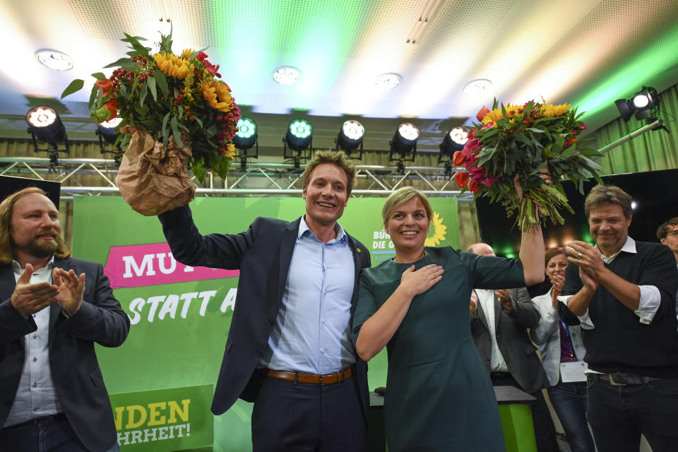 Faction leader Anton Hofreiter, top candidates Ludwig Hartmann and Katharina Schulze and party chairman Robert Habeck, from left, celebrate after the first exit polls for the Bavarian state election in Munich, southern Germany, Sunday, Oct. 14, 2018. (Sven Hoppe/dpa via AP)