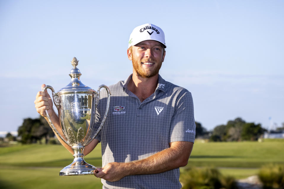 Talor Gooch holds the championship trophy after the final round of the RSM Classic golf tournament, Sunday, Nov. 21, 2021, in St. Simons Island, Ga. (AP Photo/Stephen B. Morton)