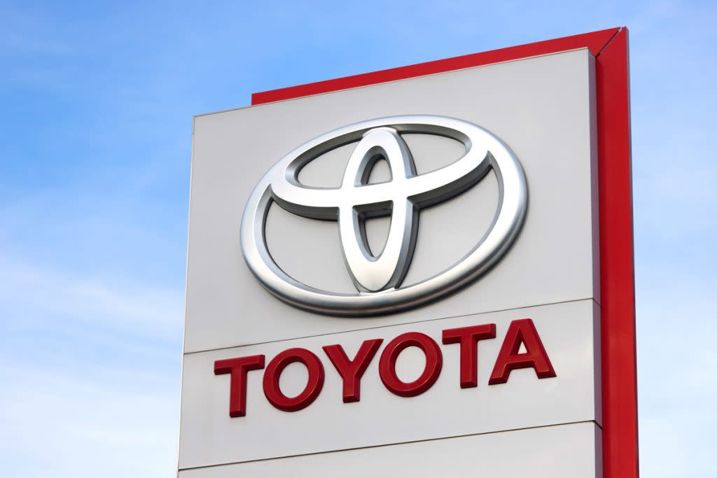 A Toyota sign is shown against blue skies. 