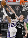 Sacramento Kings' Richaun Holmes (22) shoots against San Antonio Spurs' Jakob Poeltl during the first half of an NBA basketball game, Wednesday, March 31, 2021, in San Antonio. (AP Photo/Darren Abate)