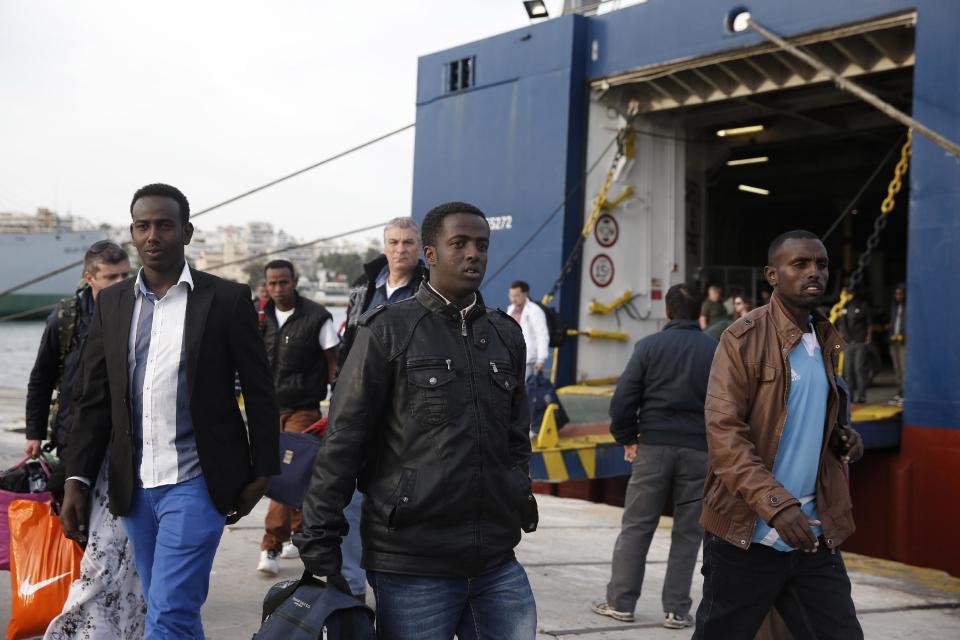 African immigrants, three of among the 32 survived from a boat accident which occurred on May 5 in Greek waters, arrive at the port of Piraeus, near Athens, on Monday, May 12, 2014. At least 22 people, including families trapped in a flooded cabin, drowned when a yacht and a dinghy crammed with migrants trying to slip into Greece capsized last week in the eastern Aegean Sea, next to the island of Samos, authorities said. (AP Photo/Petros Giannakouris)