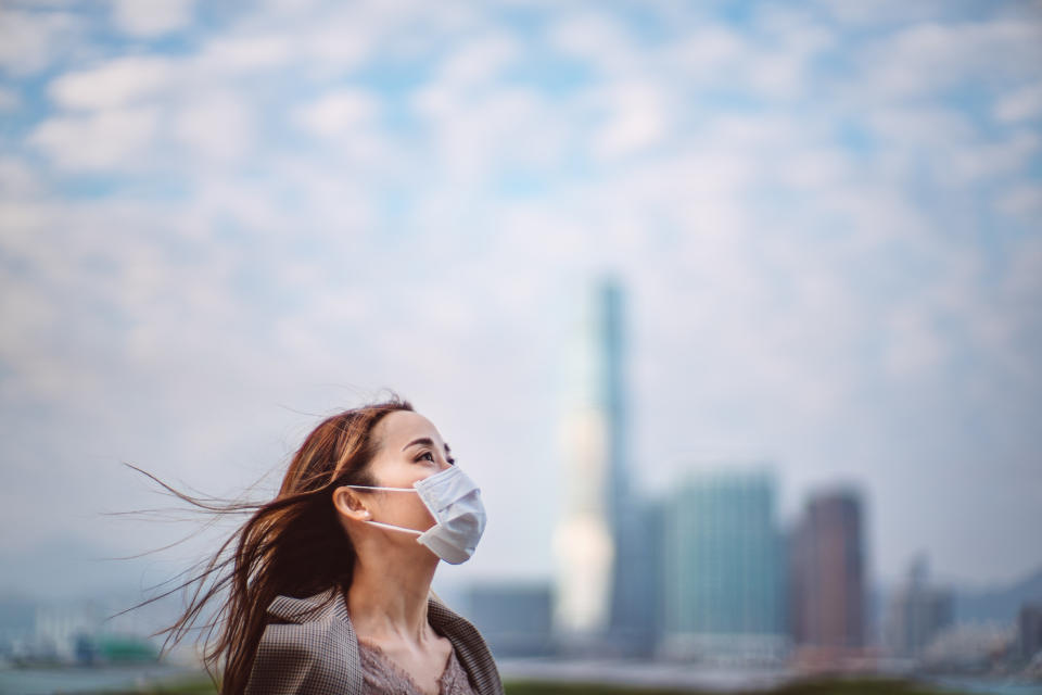 Portrait of young Asian lady with face mask to protect and prevent from the spread of viruses in the city