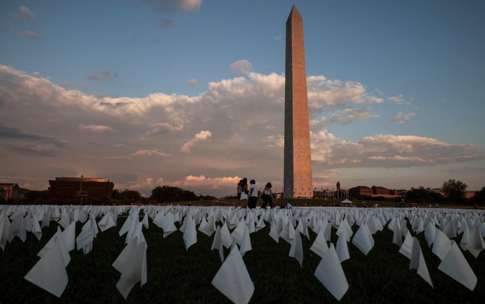 People visit the 'In America: Remember' art installation - to commemorate Americans who have died from Covid-19 - conceptualised by artist Suzanne Brennan Firstenberg near the Washington Monument on 18 September 2021 - Anna Moneymaker/Getty Images