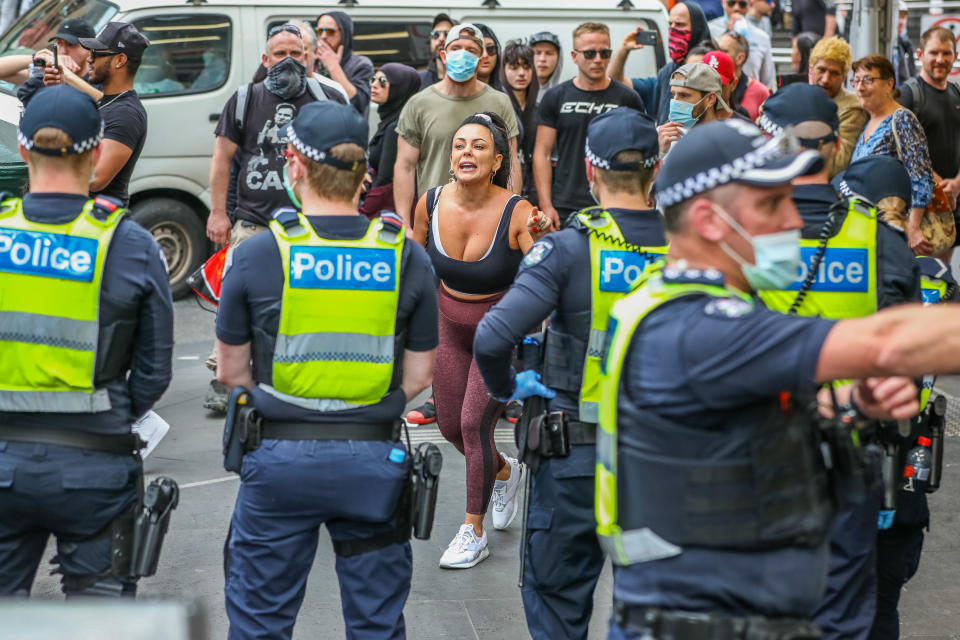 Protesters shout at police officers as violent clashes took place in Melbourne on Saturday as anger over lockdowns continues to bubble over. Source: Getty