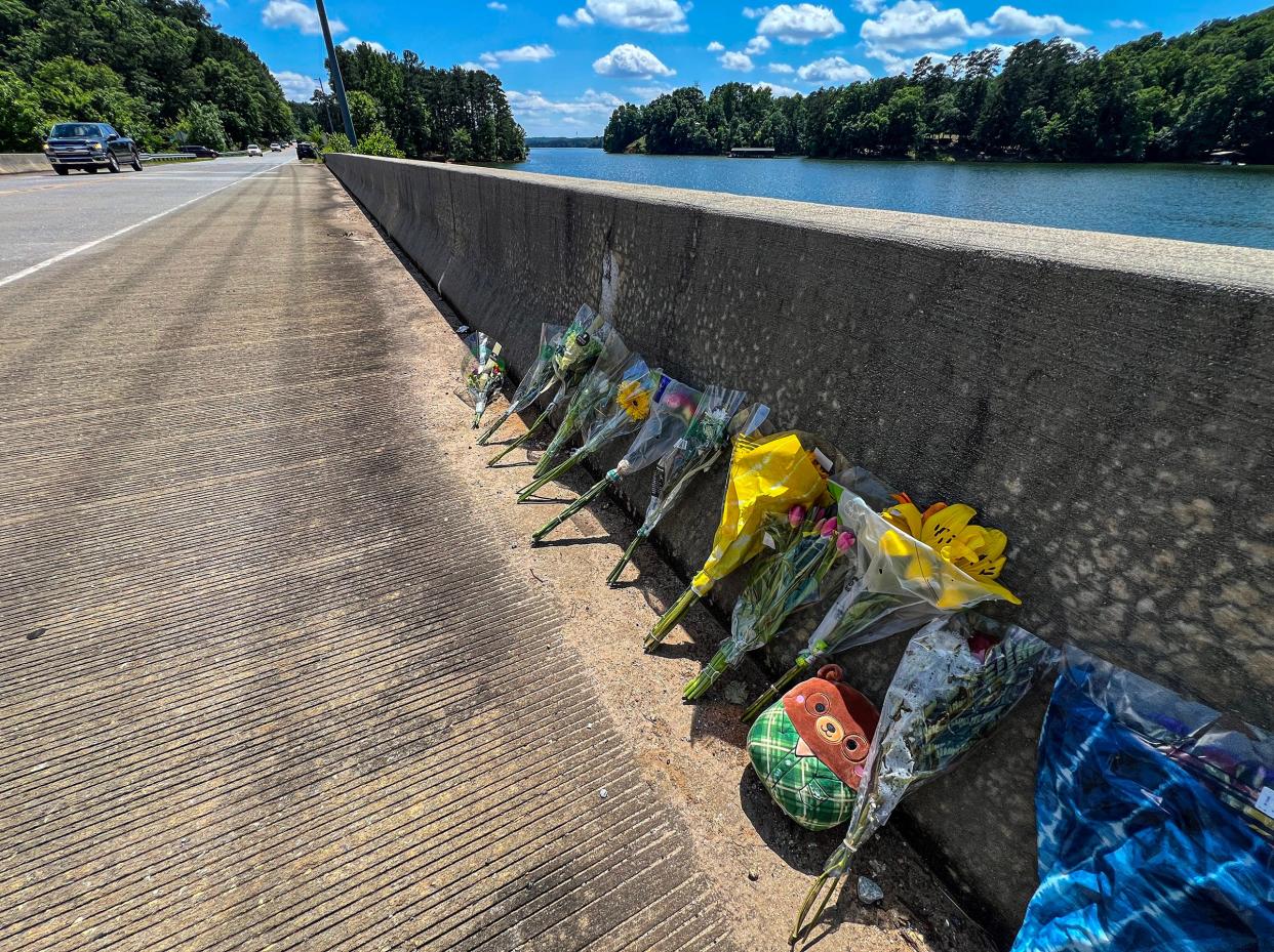 Flowers left on a bridge over Six Mile Creek along State Highway 133, in the area of Pike Road and Old Jewell Bridge Road, in Central, S.C. Monday, May 20, 2024.