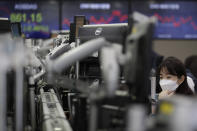 A currency trader watches computer monitors at the foreign exchange dealing room in Seoul, South Korea, Thursday, Nov. 26, 2020. Asian shares were mixed Thursday, after Wall Street took a pause from the optimism underlined in a record-setting climb earlier in the week. (AP Photo/Lee Jin-man)