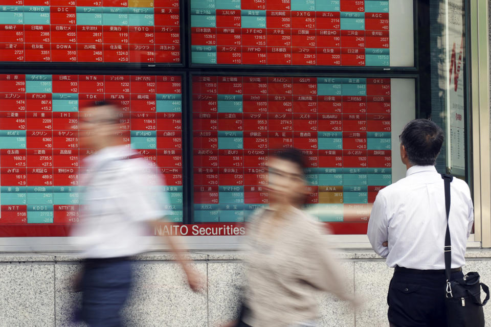 A man looks at an electronic stock board showing Japan's Nikkei 225 index at a securities firm in Tokyo Tuesday, Sept. 10, 2019. Asian shares were mixed Tuesday after a day of listless trading on Wall Street, as investors awaited signs on global interest rates.(AP Photo/Eugene Hoshiko)