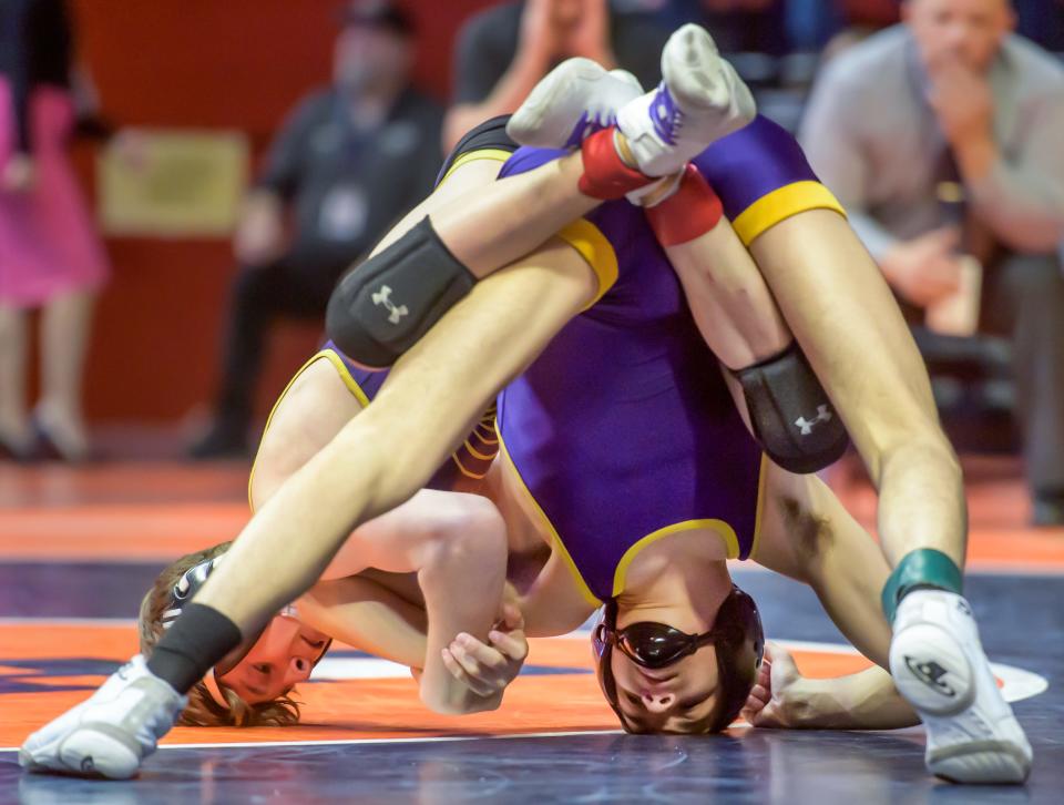 Carlyle's Tyson Waughtel, top, and Farmington's Keygan Jennings battle it out in the 113-pound match of the  Class 1A state wrestling tournament Saturday, Feb. 18, 2023 at State Farm Arena in Champaign.