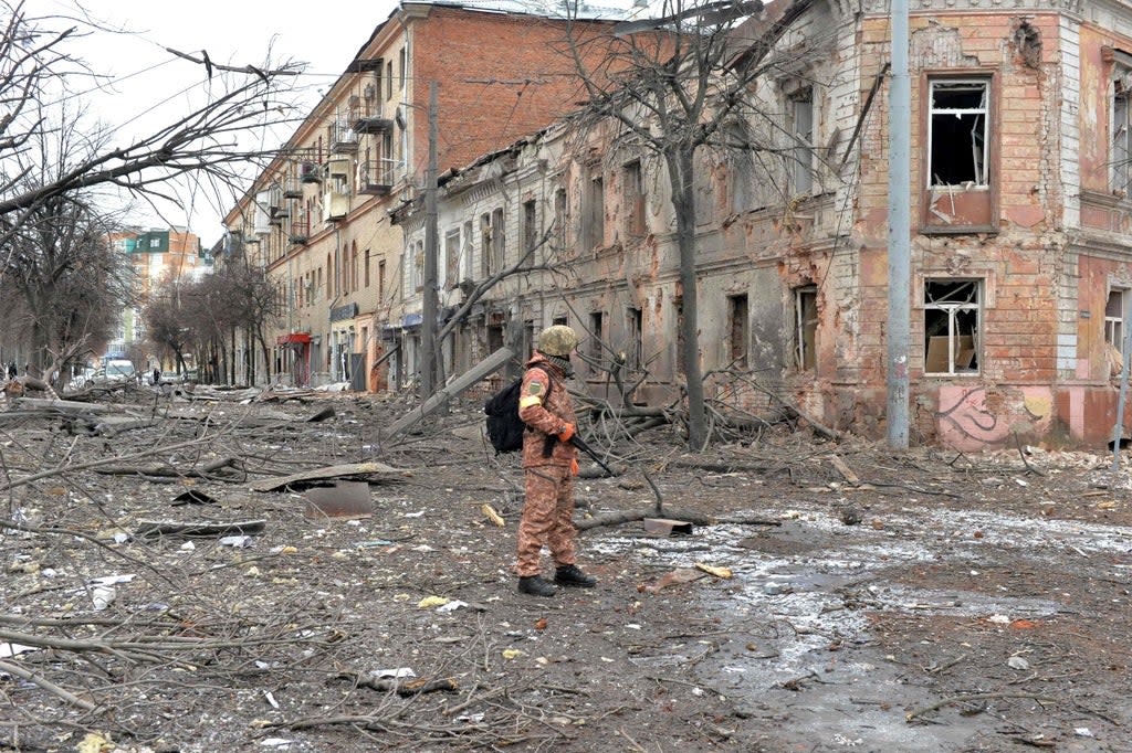 A member of the Ukrainian Territorial Defence Forces surveys the extensive damage following a shelling in Kharkiv  (AFP via Getty Images)