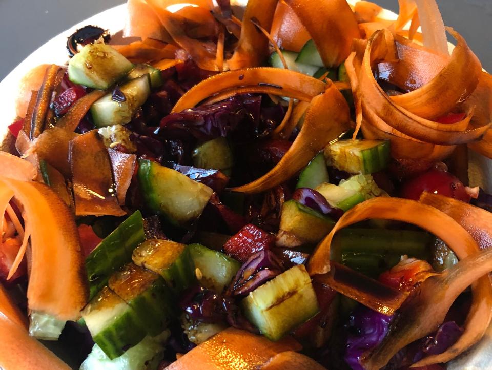 colorful salad in a bowl with carrots and cucumbers