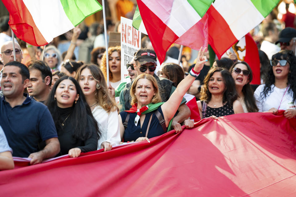 People attend a protest rally in Hamburg, Germany, Saturday, Sept. 16, 2023 to mark the first anniversary of the death of Mahsa Amini in the custody of Iran’s morality police last year, sparking worldwide protests against Iran’s conservative Islamic theocracy. (Jonas Walzberg/dpa via AP)