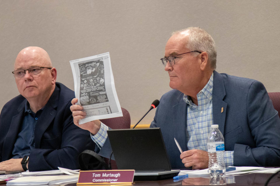 Tippecanoe County Commissioner Tom Murtaugh, right, questions Benito Muñoz about a poster that was made promoting the rodeo and concert event Muñoz plans to host on his property if his exception is approved, on May 2, 2022, in Lafayette. Commissioner Tracy Brown is at left.