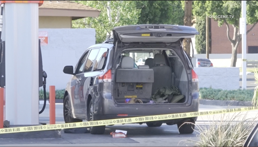 A van behind police tape at a gas station in Bellflower. The Los Angeles County Sheriff’s Department says an off-duty LAPD officer was hit by a stray bullet in what appeared to be a gang-related shooting on May 5, 2024. (OnScene.TV)