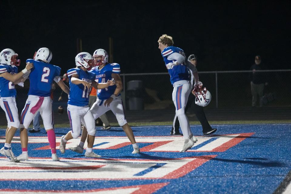 Truitt Manuel (12) and Lane Johnson (11) celebrate alongside their teammates their victory over Franklin last season. The Falcons host East Rutherford on Friday night.