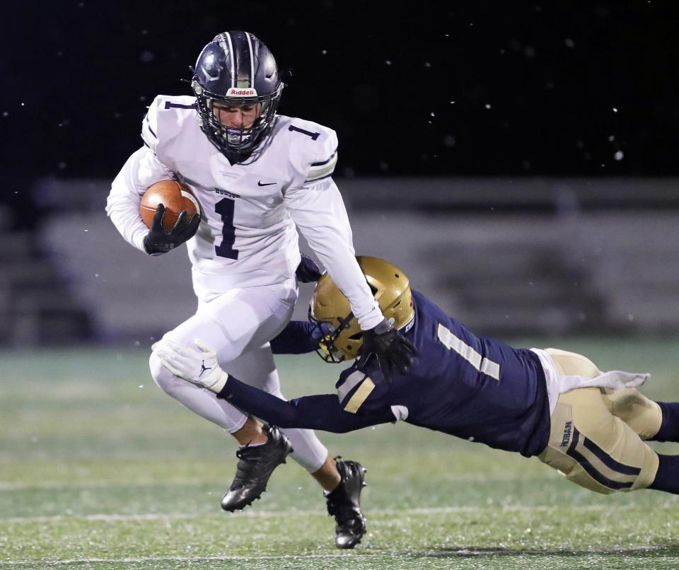 Hudson wide receiver Gio DePompei, left, is brought down by Hoban defensive back Tysen Campbell during the first half of a Division II regional final, Friday, Nov. 18, 2022.