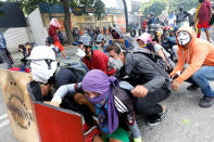 <p>Demonstrators take cover at a rally during a strike called to protest against Venezuelan President Nicolas Maduro’s government in Caracas, Venezuela, July 26, 2017. (Photo: Andres Martinez Casares/Reuters) </p>