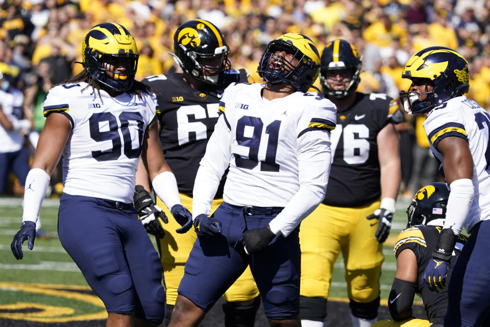 Michigan linebacker Taylor Upshaw (91) celebrates after making a tackle during the first half of an NCAA college football game against Iowa, Saturday, Oct. 1, 2022, in Iowa City, Iowa. (AP Photo/Charlie Neibergall)