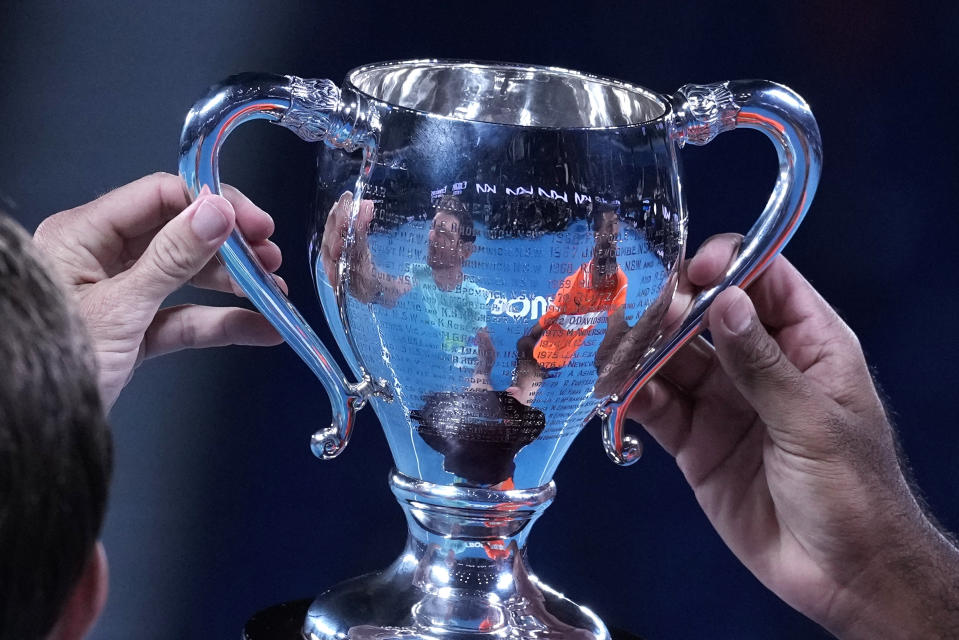 Rohan Bopanna, right, of India and Matthew Ebden of Australia pose with their trophy after defeating Simone Bolelli and Andrea Vavassori of Italy in the men's doubles final at the Australian Open tennis championships at Melbourne Park, Melbourne, Australia, Saturday, Jan. 27, 2024. (AP Photo/Alessandra Tarantino)