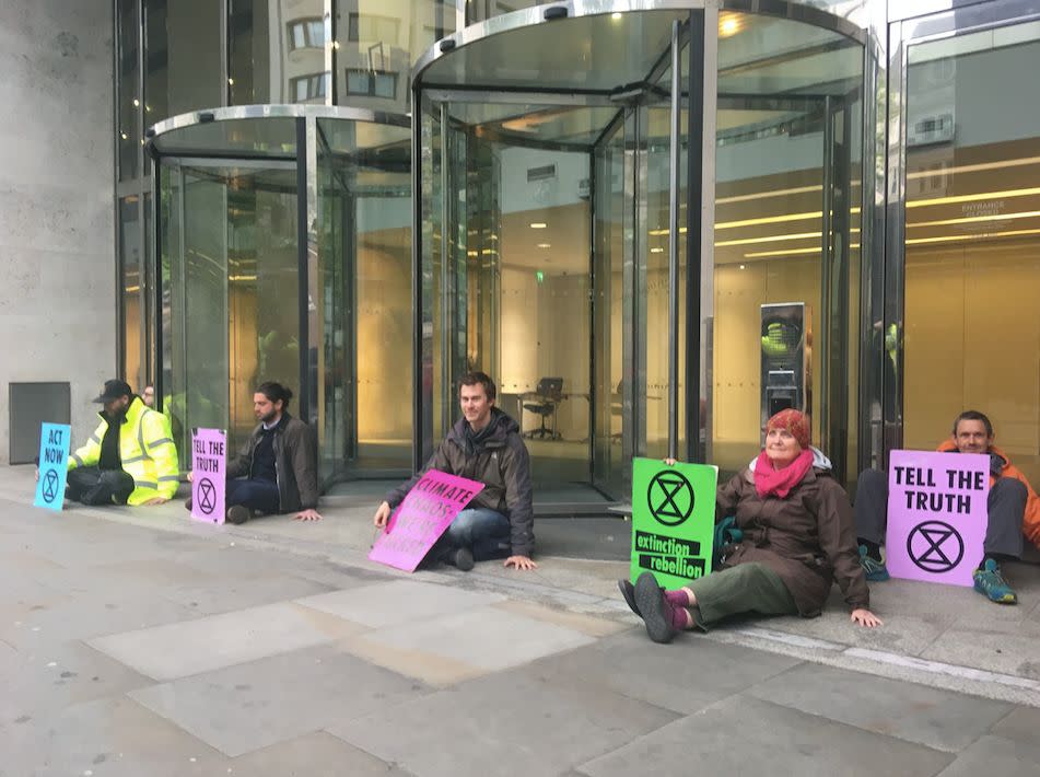 A second group of Extinction Rebellion protesters, five men and one woman, glued themselves to an entrance of the London Stock Exchange (PA)