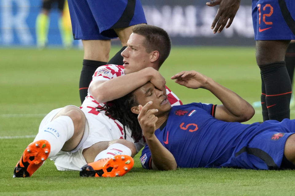 Croatia's Mario Pasalic holds the head of Netherlands' Nathan Ake after hitting him in the face with his boot during the Nations League semifinal soccer match between the Netherlands and Croatia at De Kuip stadium in Rotterdam, Netherlands, Wednesday, June 14, 2023. (AP Photo/Peter Dejong)